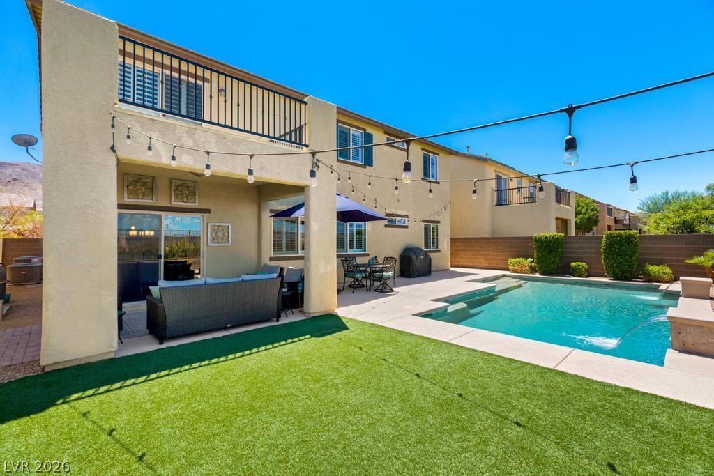 Image 2: A spacious backyard oasis features a glistening po