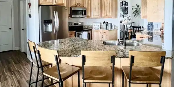 Image 3: A well-appointed culinary space featuring light wo