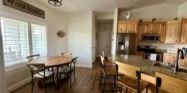 Image 4: A well-appointed kitchen and dining area features