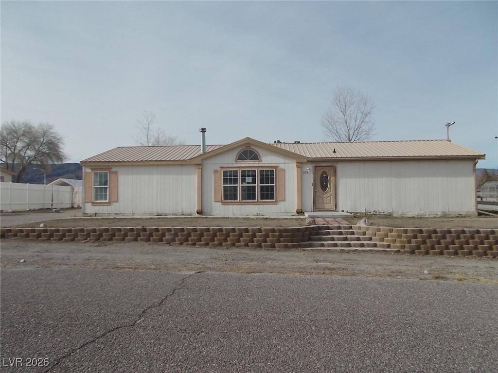 Image 1: View of front of home featuring a metal roof