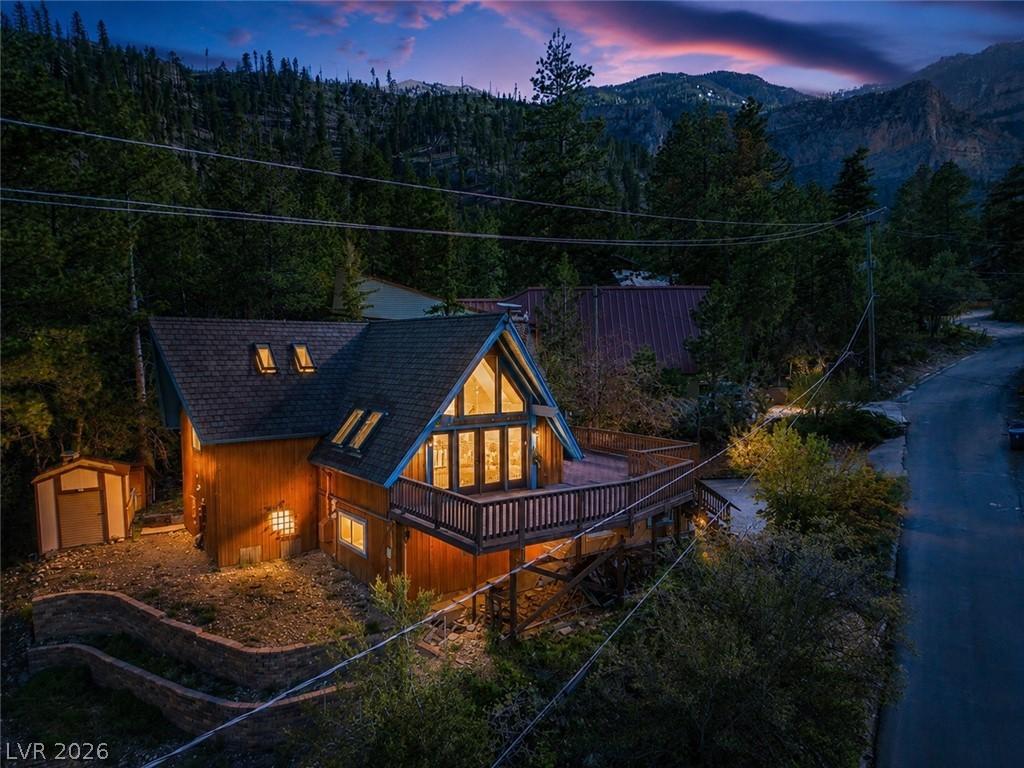 Image 1: A gorgeous setting frames this cedar-sided A-frame