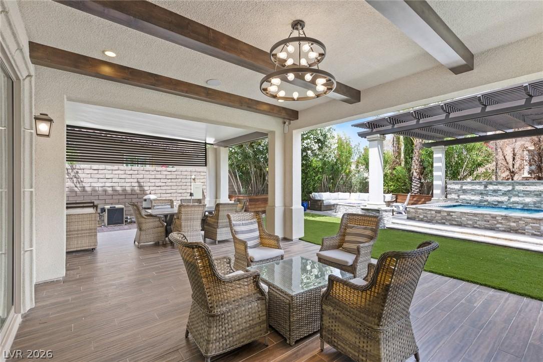 Image 3: An inviting covered patio offers ample seating and