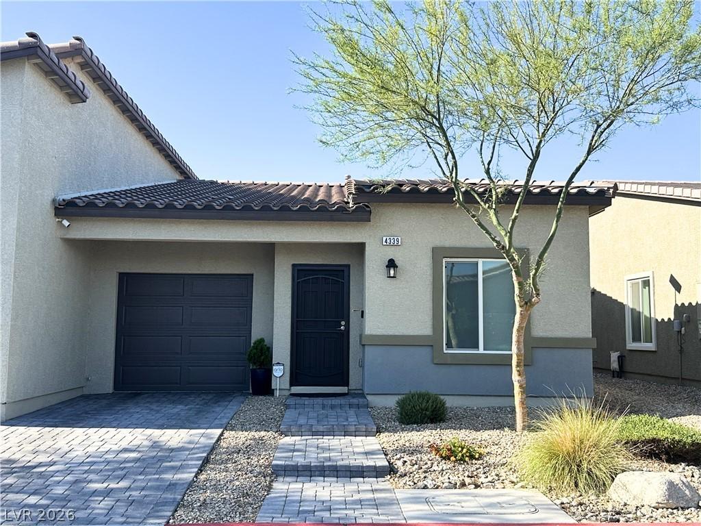 Image 1: A well-maintained single-story townhouse with atta