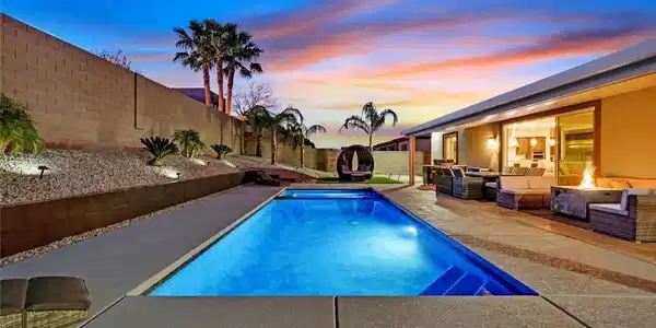 Image 4: A sparkling swimming pool anchors this private bac