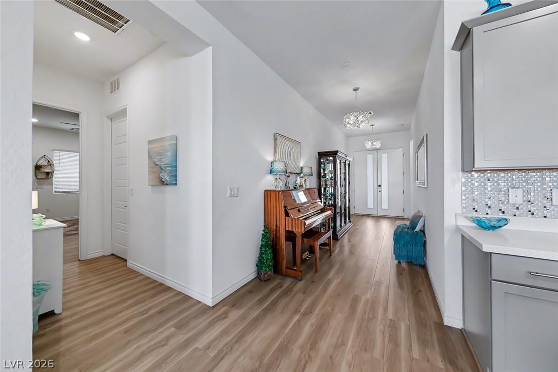 Image 4: A graceful entry hall welcomes with warm wood floo