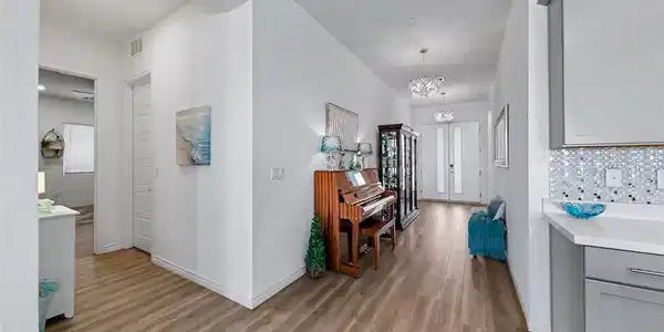 Image 4: A graceful entry hall welcomes with warm wood floo