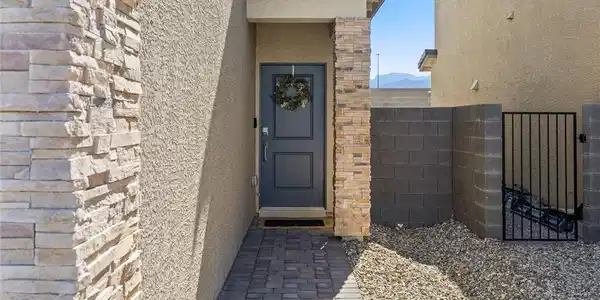 Image 3: A welcoming entry features stone accents, a durabl