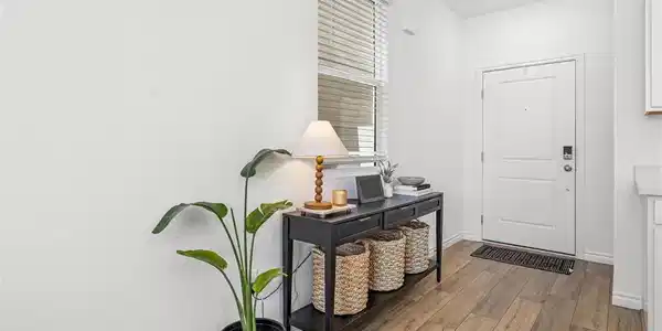 Image 4: A welcoming entryway with rich wood-look flooring