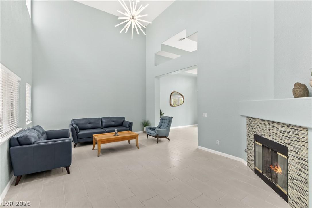 Image 3: A spacious living area with soaring ceilings and a