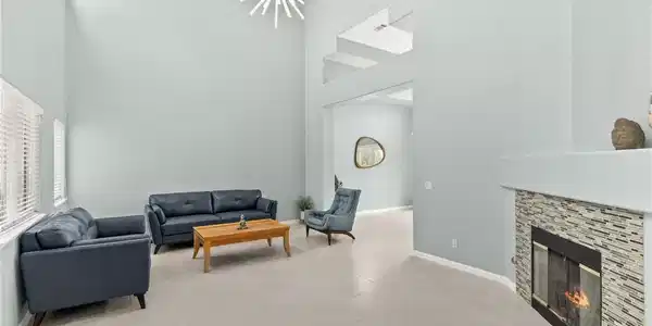 Image 3: A spacious living area with soaring ceilings and a
