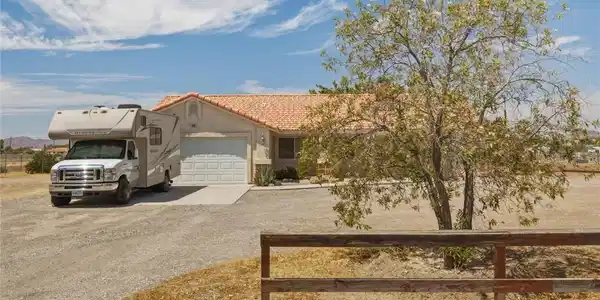 Image 4: A classic tile roof and spacious driveway anchor t