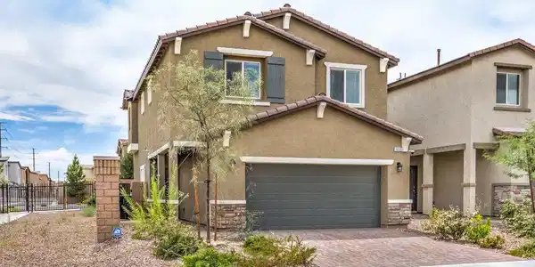 Image 2: An inviting two-story exterior showcases a tile ro
