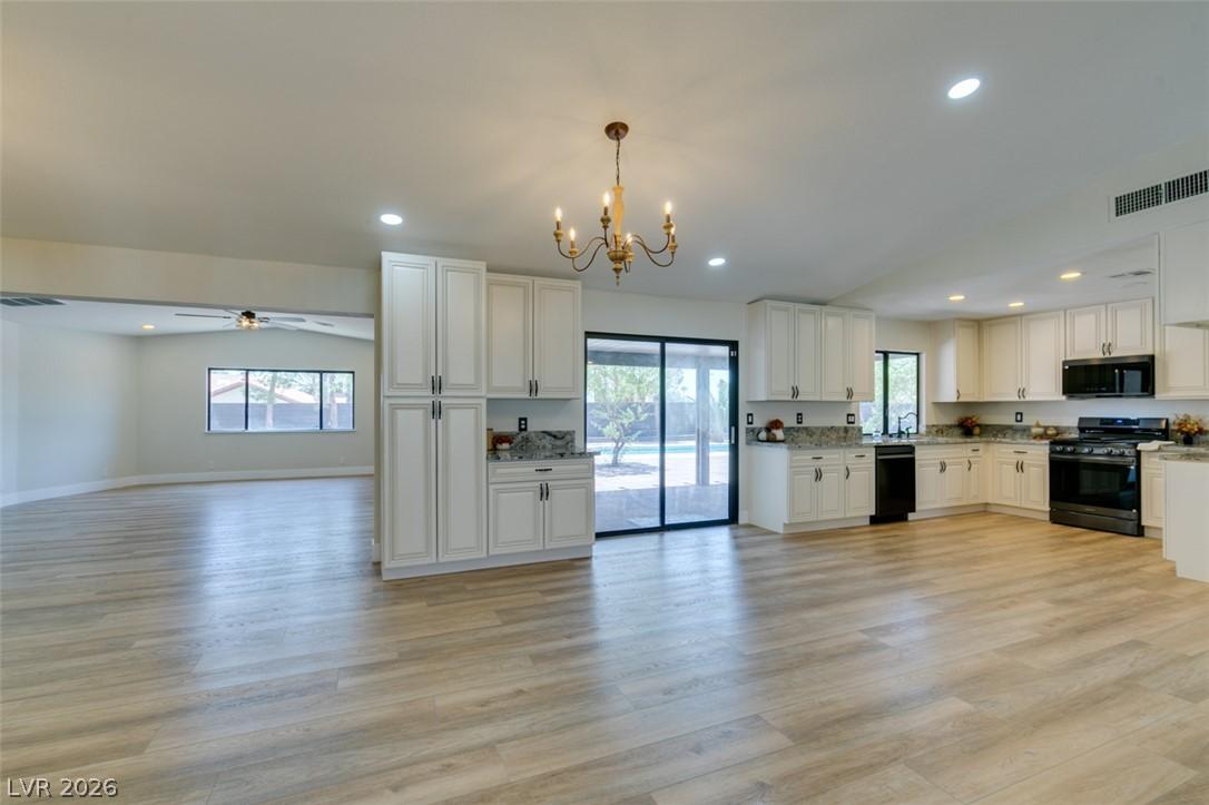Image 3: Bright, open-concept kitchen featuring clean lines