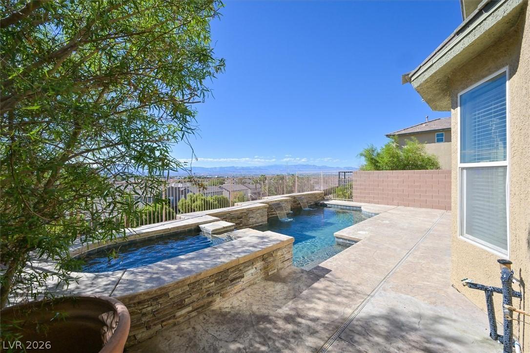 Image 4: An inviting backyard oasis with a pristine pool an