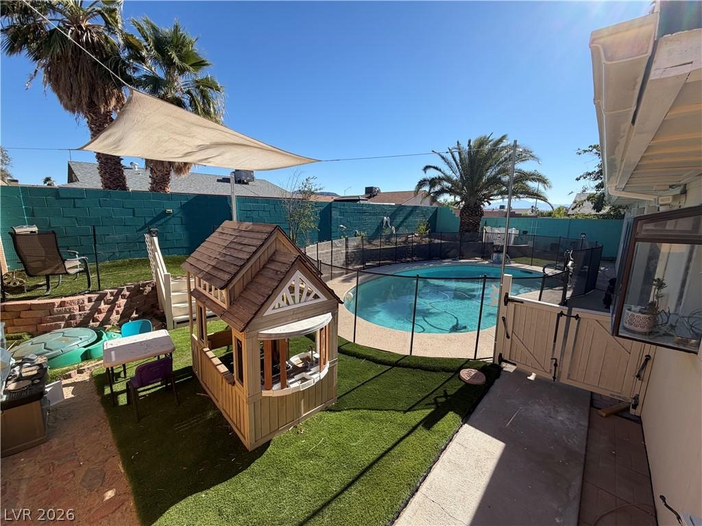 Image 1: An inviting backyard oasis offers a sparkling pool