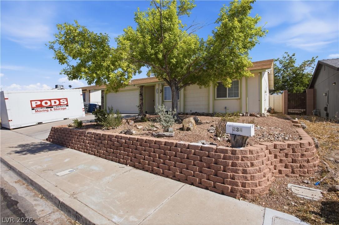 Image 3: A welcoming facade offers an attached garage and a