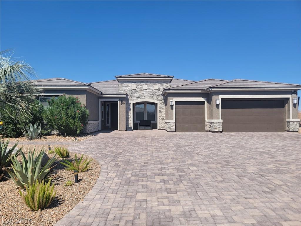 Image 1: An inviting paver driveway leads to a contemporary