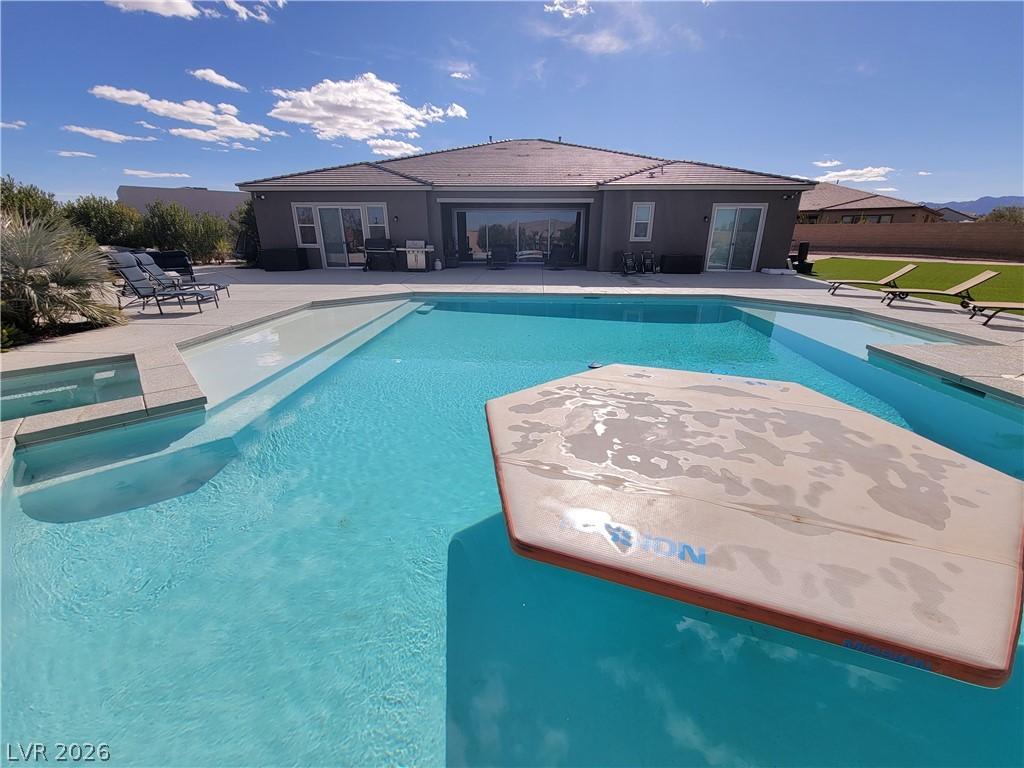 Image 2: A refreshing outdoor pool with integrated spa and