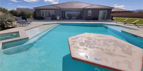 Image 2: A refreshing outdoor pool with integrated spa and