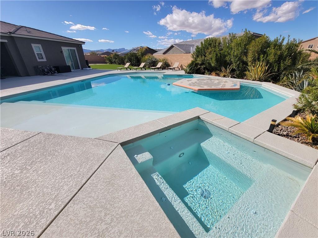 Image 3: An inviting private pool and spa offers luxurious