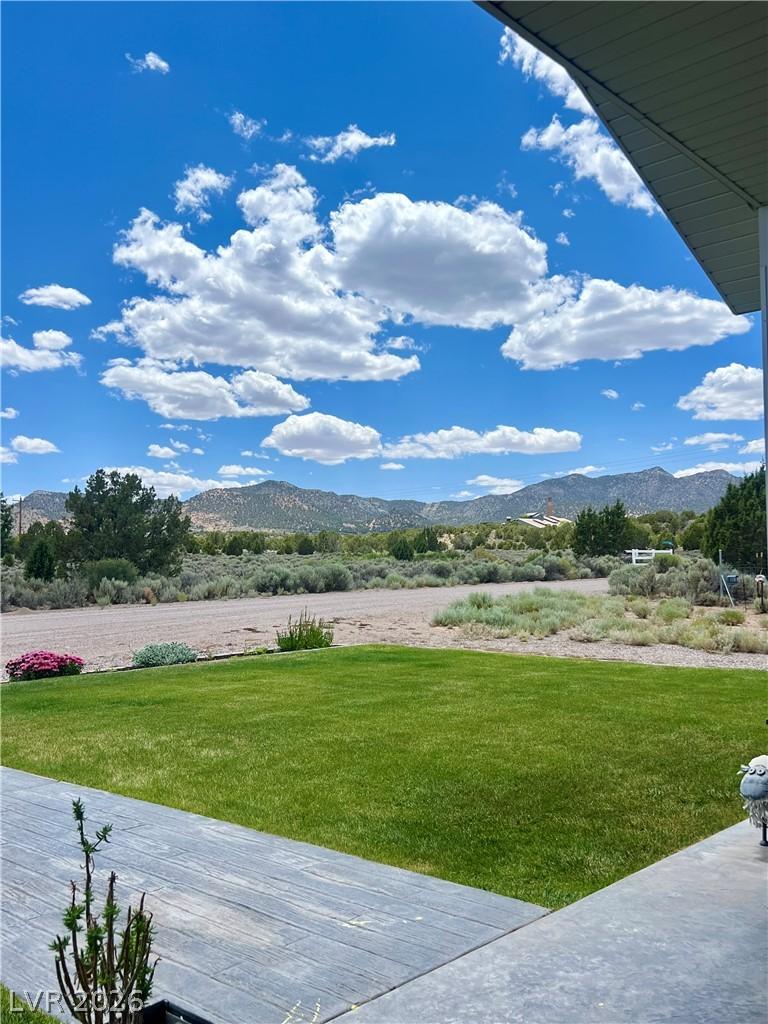 Image 2: Expansive green lawn fronts a picturesque, distant
