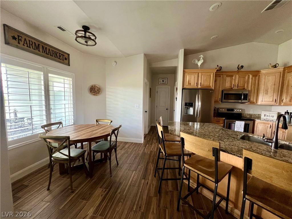 Image 4: A well-appointed kitchen and dining area features