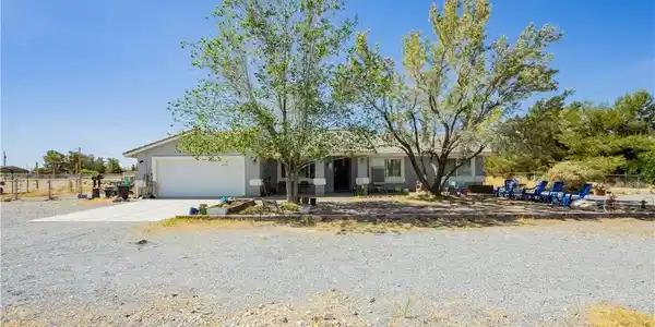 Image 4: Ranch-style house with an attached garage, stucco