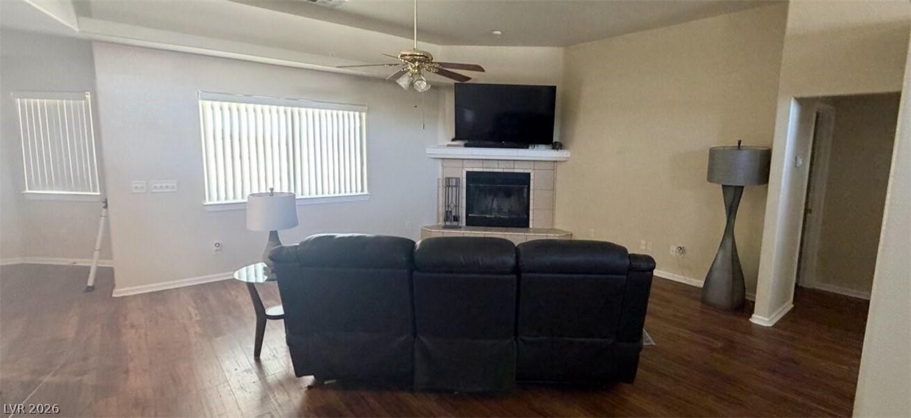 Image 3: This living area showcases rich hardwood flooring,
