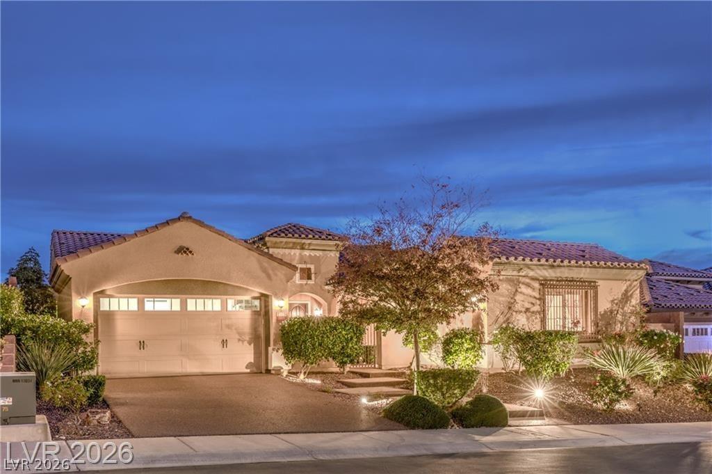 Image 3: An inviting evening view highlights the home's met