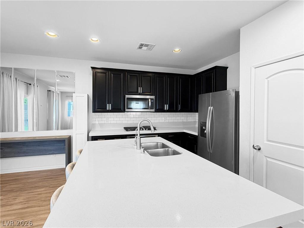 Image 2: A well-appointed kitchen features a large island a
