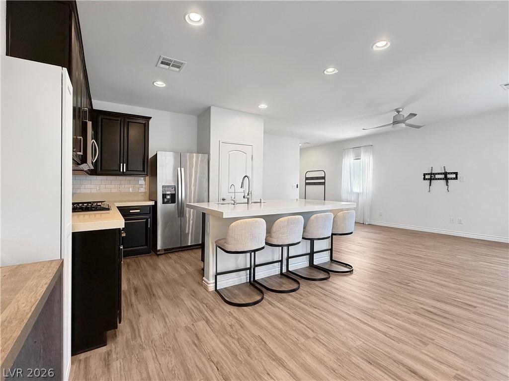 Image 3: A contemporary kitchen and living area featuring s