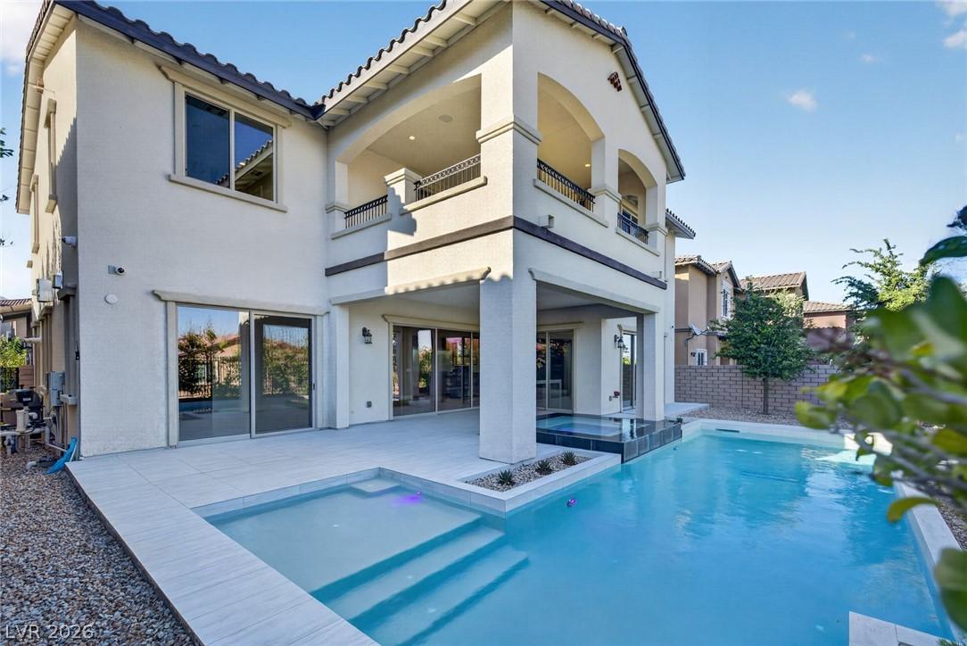 Image 2: An inviting backyard oasis offers a sparkling pool