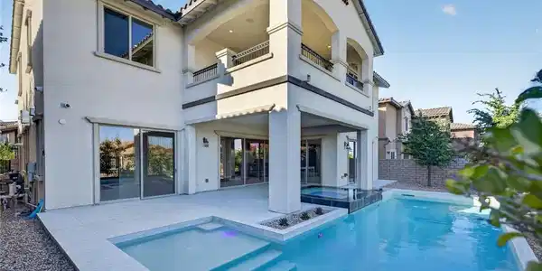 Image 2: An inviting backyard oasis offers a sparkling pool