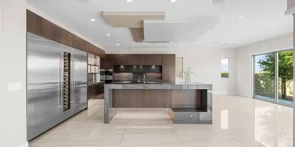 Image 3: A pristine modern kitchen features a waterfall isl