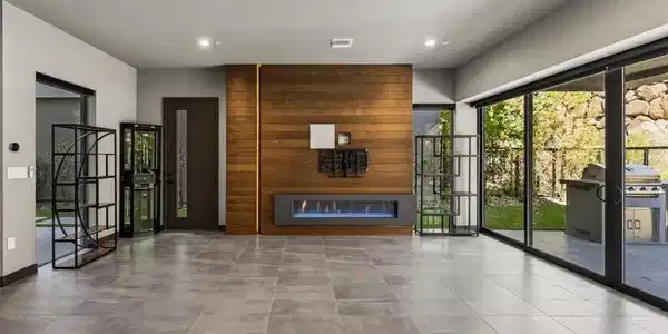 Image 4: A modern linear fireplace anchors the living room,