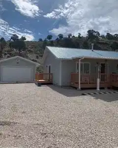 Image 2: View of front of property with a metal roof, a det