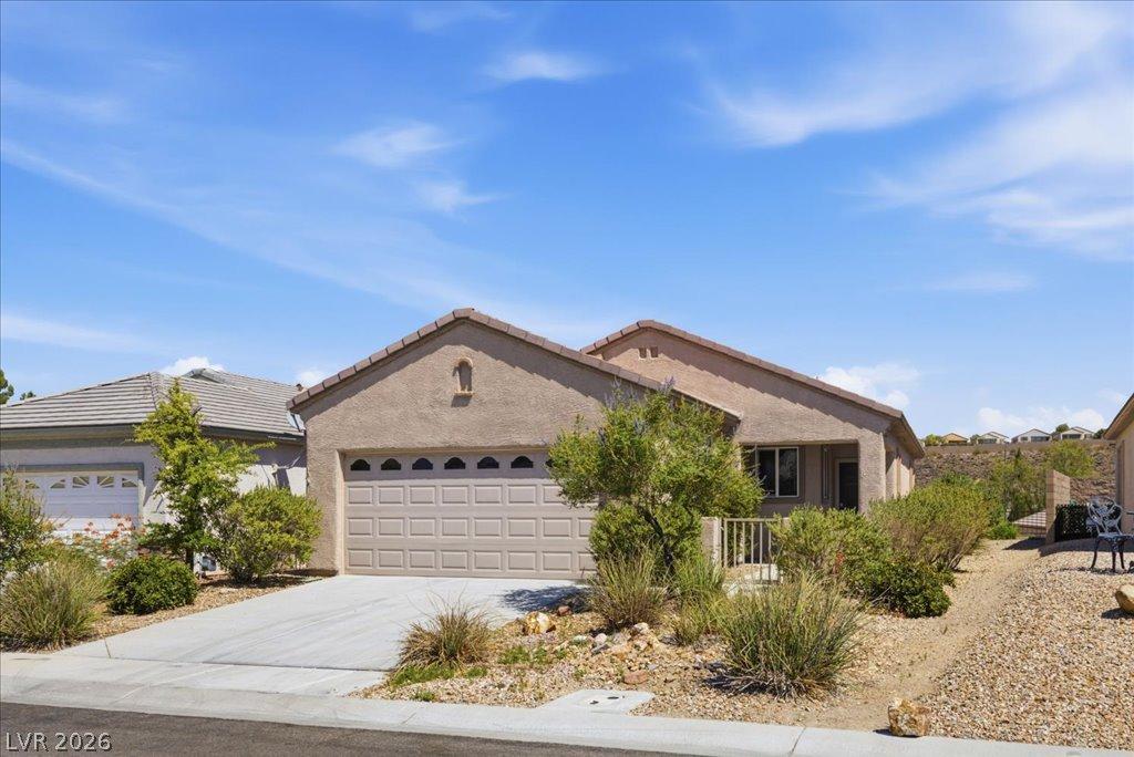 Image 2: A well-maintained stucco home with an attached gar