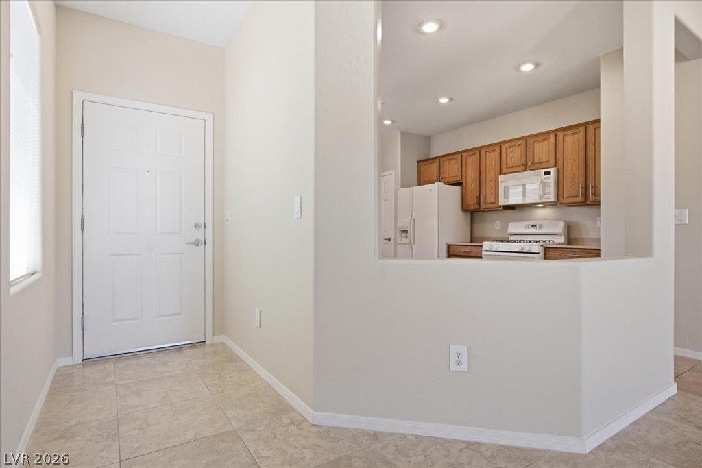 Image 4: A welcoming entryway with durable tile flooring le
