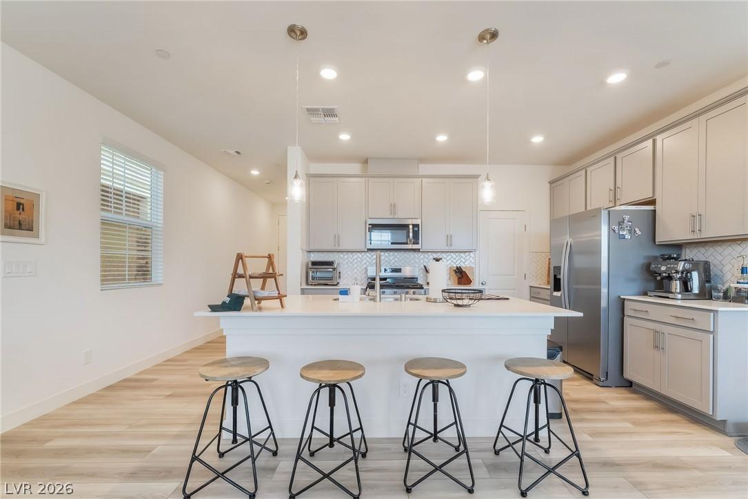 Image 2: A contemporary kitchen features an inviting island
