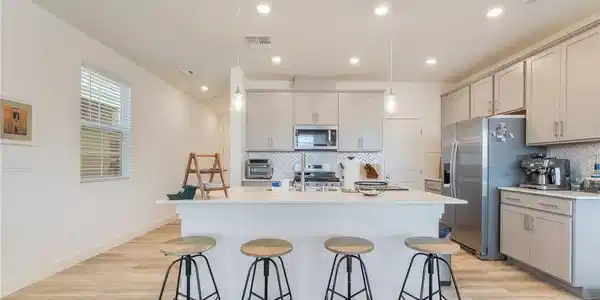 Image 2: A contemporary kitchen features an inviting island