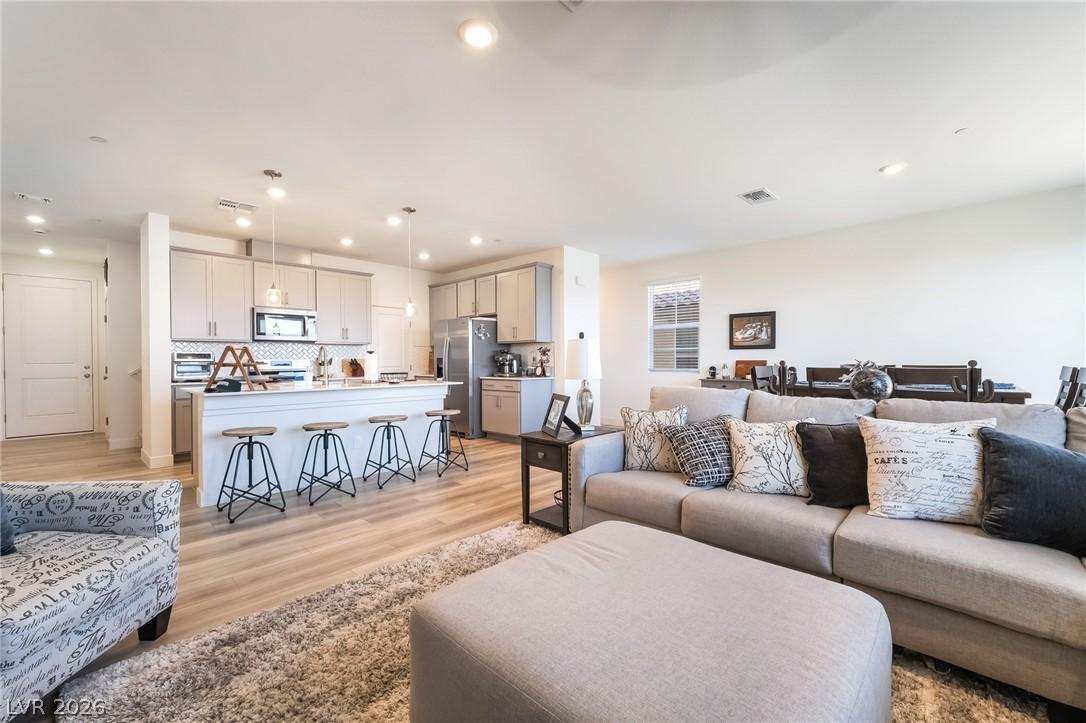 Image 3: An open-concept living space with a kitchen island