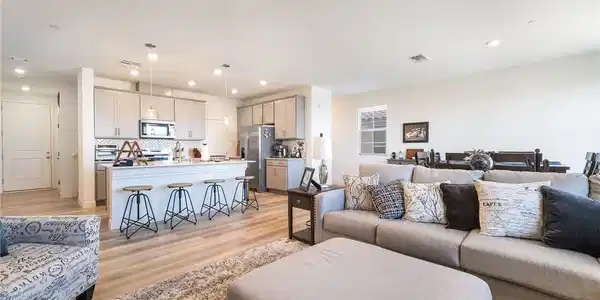 Image 3: An open-concept living space with a kitchen island