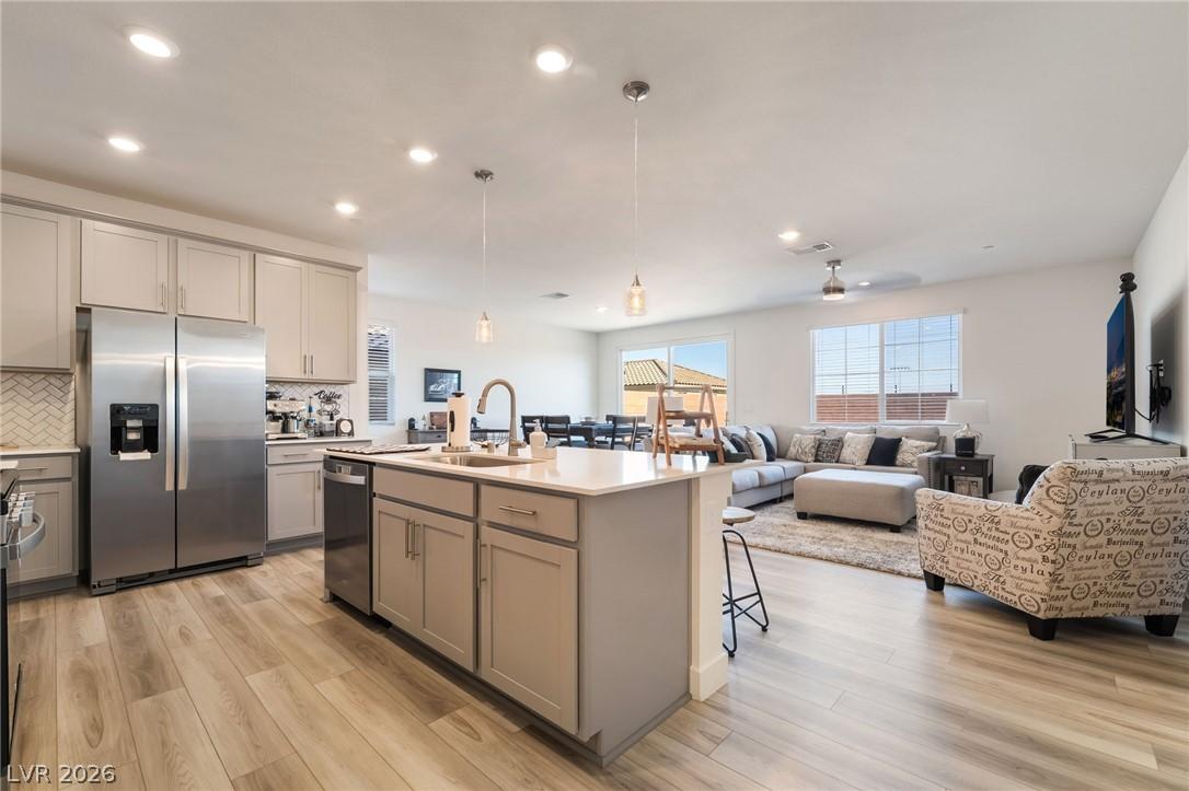 Image 4: A well-lit, open-concept kitchen flows seamlessly