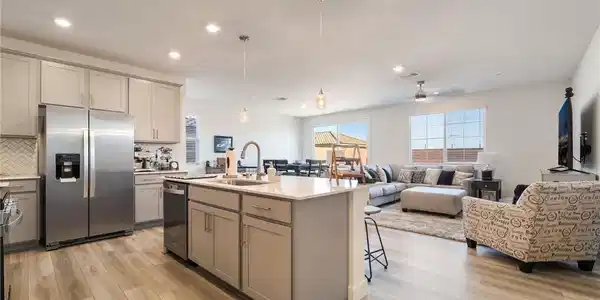 Image 4: A well-lit, open-concept kitchen flows seamlessly