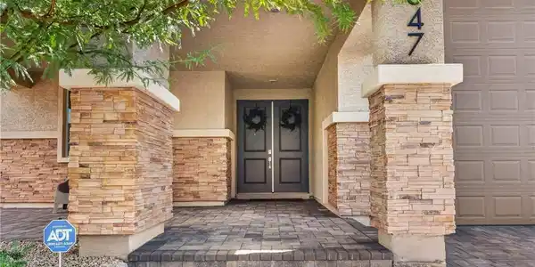 Image 3: Stately stone columns frame a welcoming double-doo