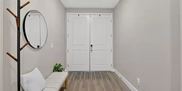 Image 4: Double doors open into a welcoming foyer accented