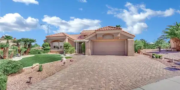 Image 2: An elegant paver driveway leads to the double gara