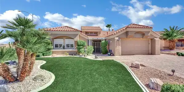 Image 3: A classic Spanish tile roof and manicured lawn cre
