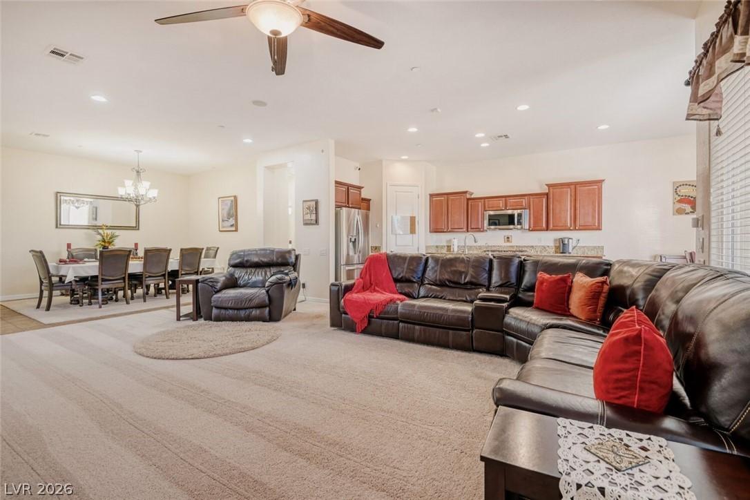 Image 2: Living room features plush carpets with a ceiling