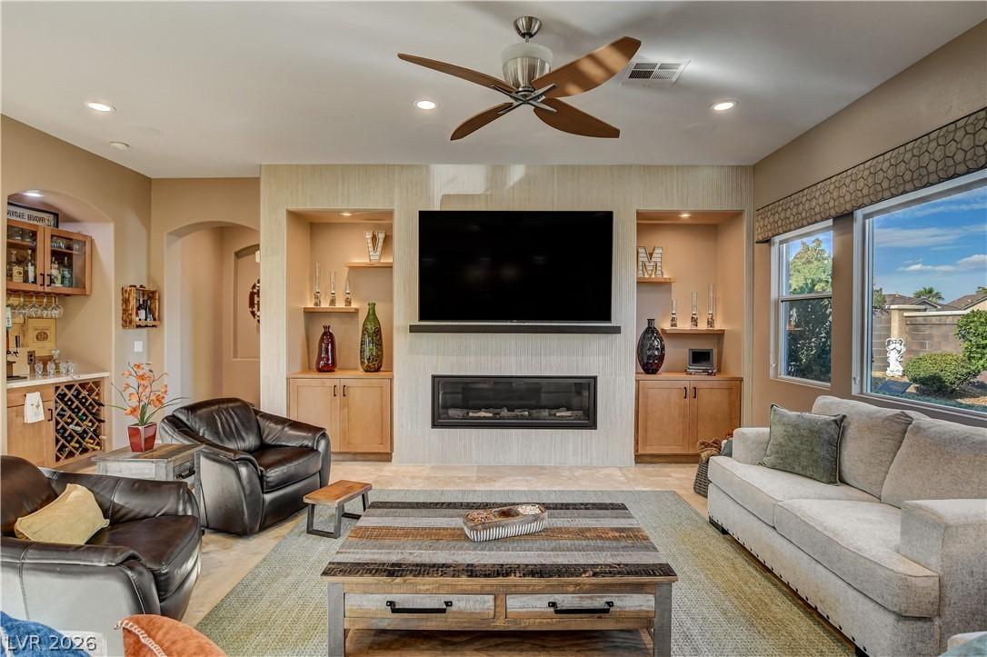 Image 2: A refined living space features a cozy fireplace,